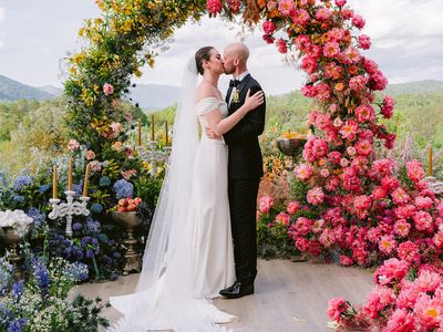 Wedding Couple Kissing By Flower Arch