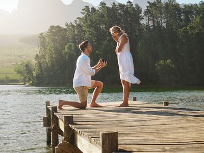 Man proposing to his girlfriend on a dock