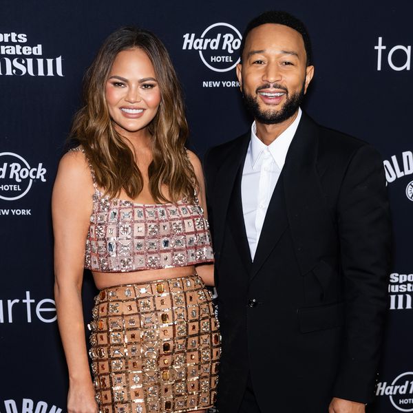 Chrissy Teigen in Two-Piece Sparkly Set and John Legend in Black Tuxedo While Posing on Red Carpet