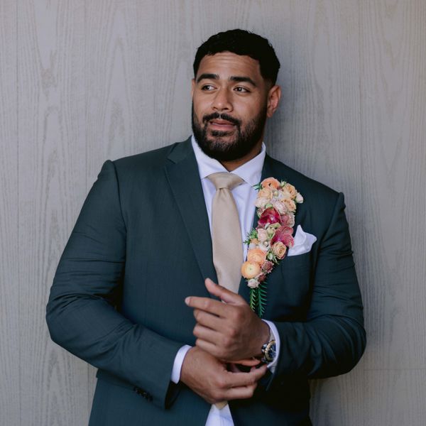 Groom in Dark Suit Jacket With Oversized Floral Boutonnière