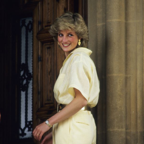 Princess Diana Smiling and Looking Behind Her Shoulder in Yellow Jumpsuit
