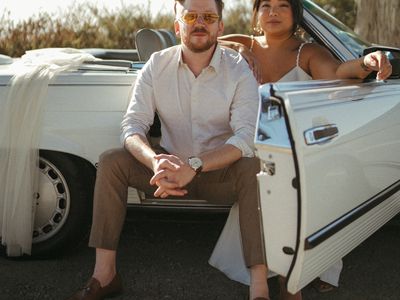 Portrait of Bride and Groom in Vintage White Car