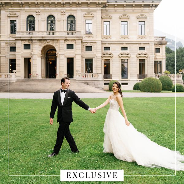My Rich BFF Vivian Tu in Strapless Wedding Dress With Hair Up Posing With Groom in Black Tuxedo In Front of Italian Villa