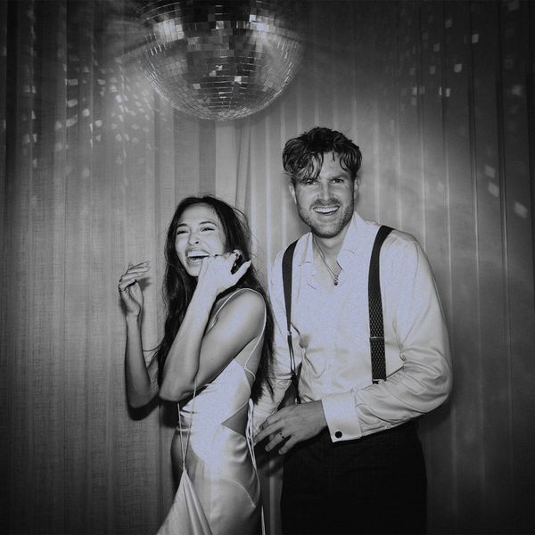 bride and groom under a disco ball