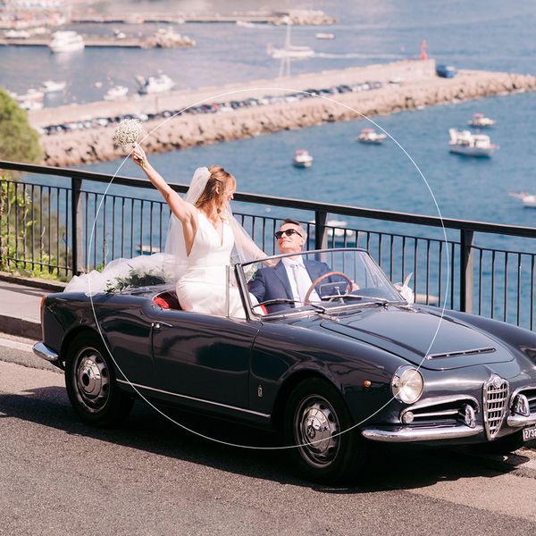 Bride and groom in car along Italian coast