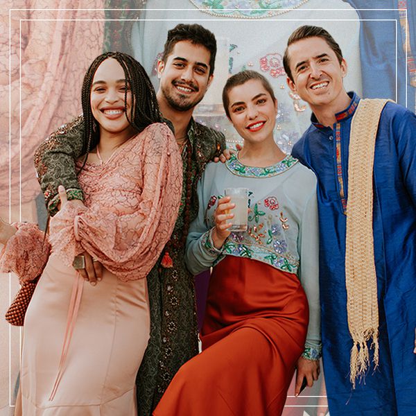 two female and two male wedding guests smiling