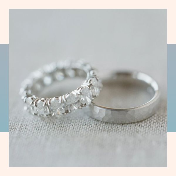 Diamond eternity band and polished wedding band on linen backdrop