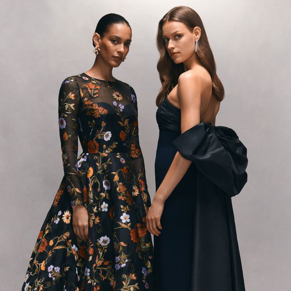 two models posing in black formal gowns 