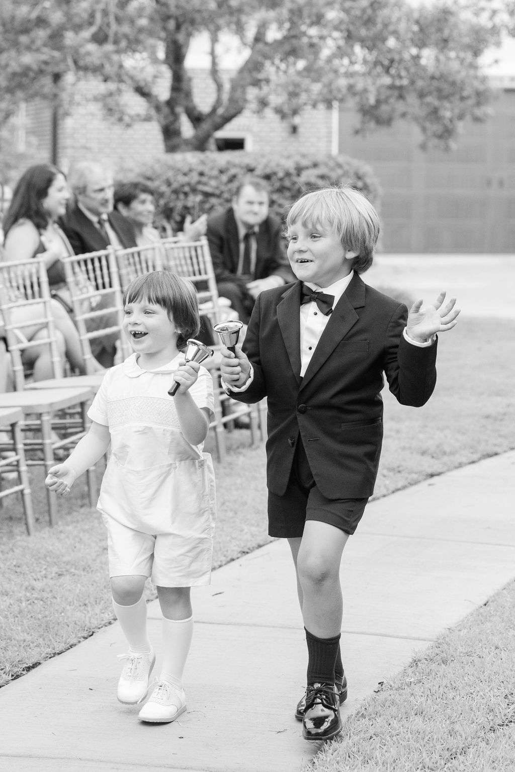 Ring bearers ringing bells as they walk down the aisle