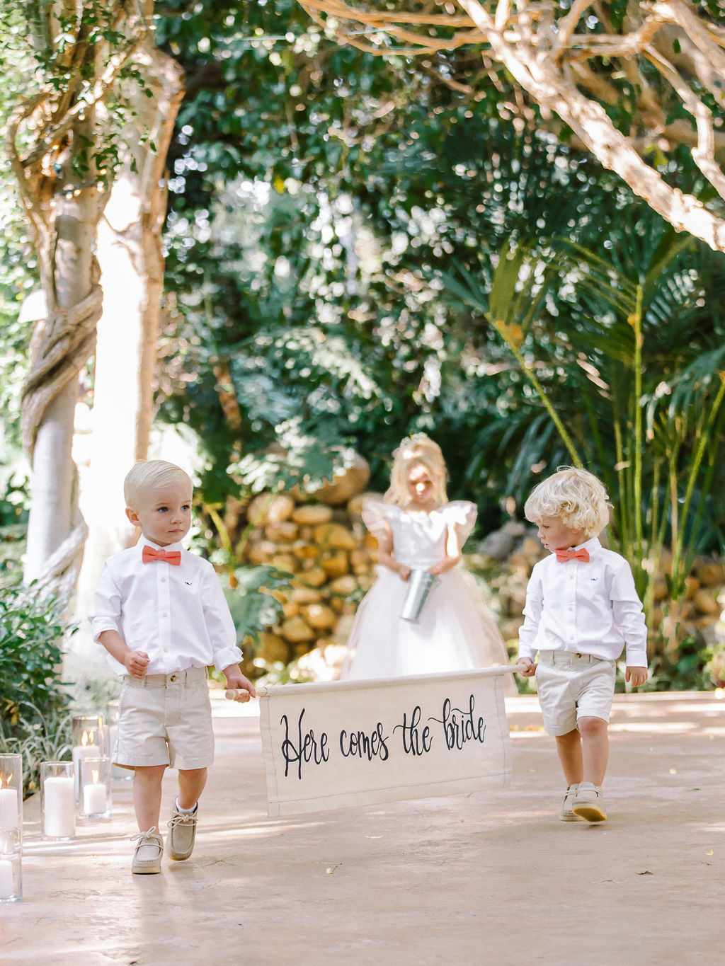 Ring Bearers Holding Each End of a Banner Sign