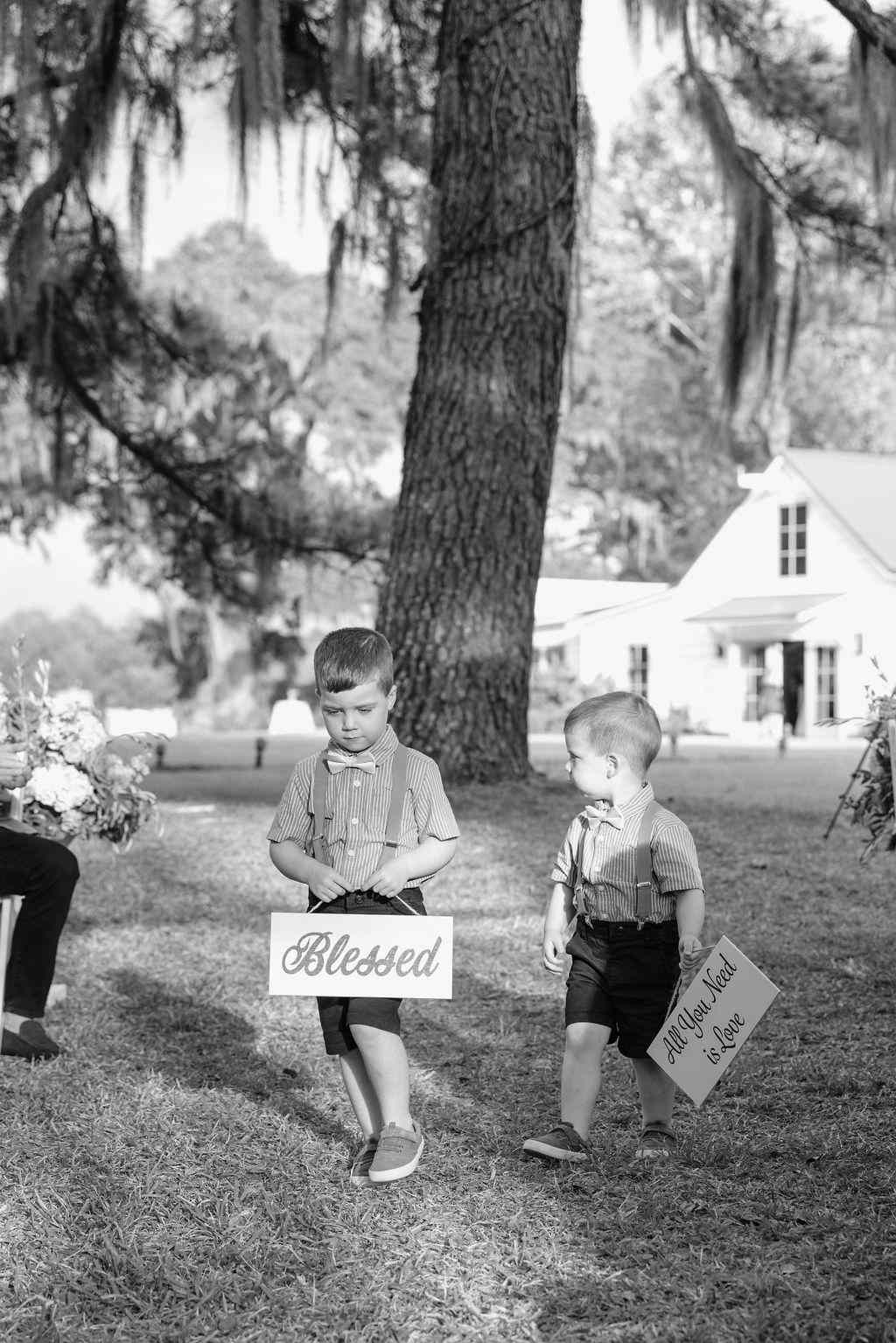 Ring Bearers Holding Signs With Positive Messages