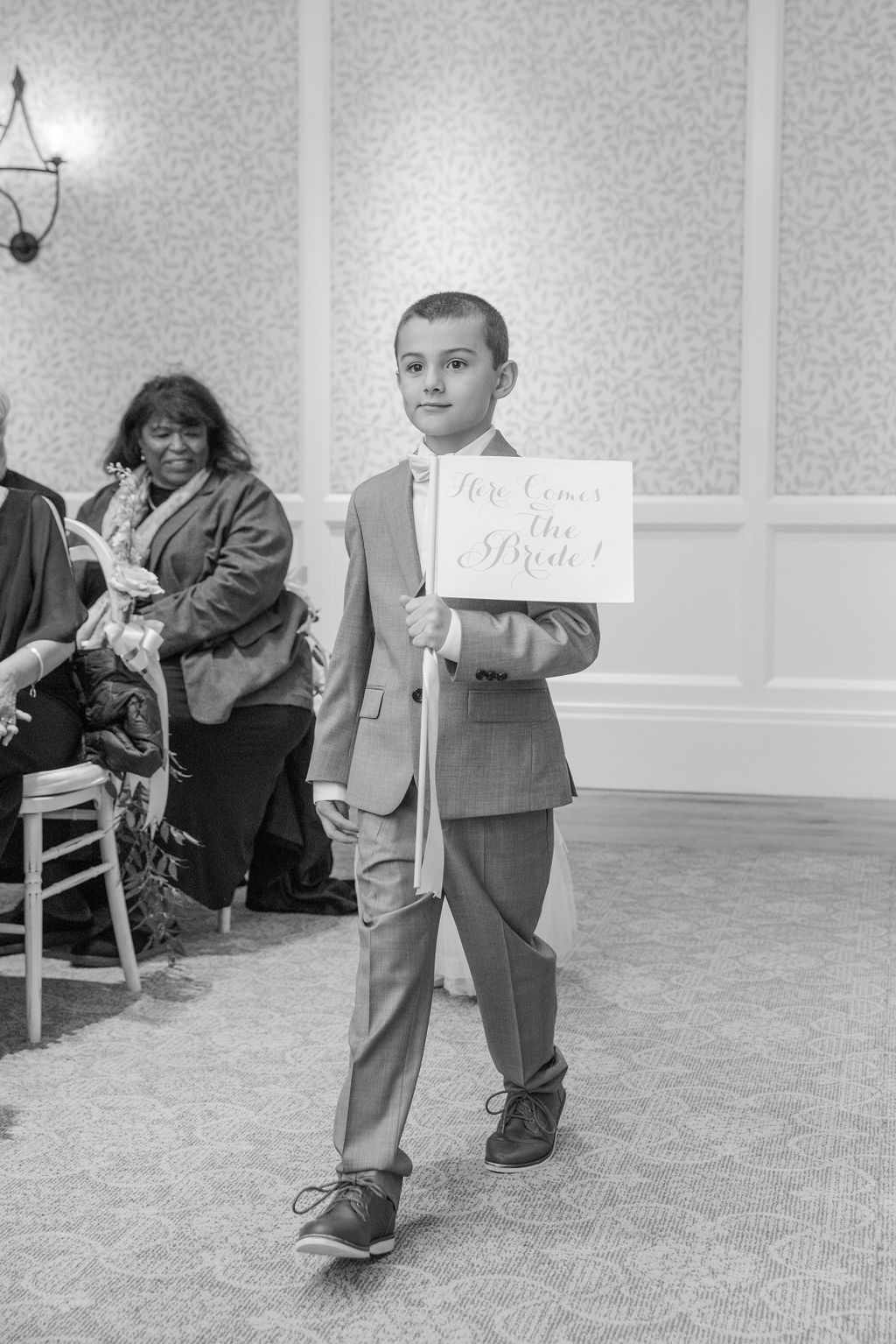 Ring Bearer Holding a Flag Sign With Streamer