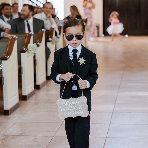 Ring Bearer Holding Funny Sign Down the Aisle