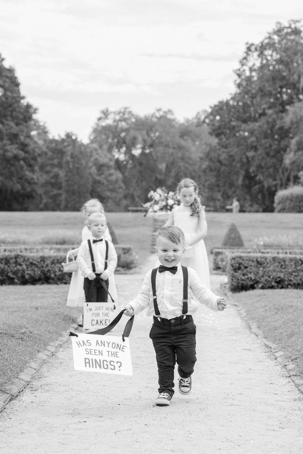 Ring Bearer Holding Funny Sign With Ribbon