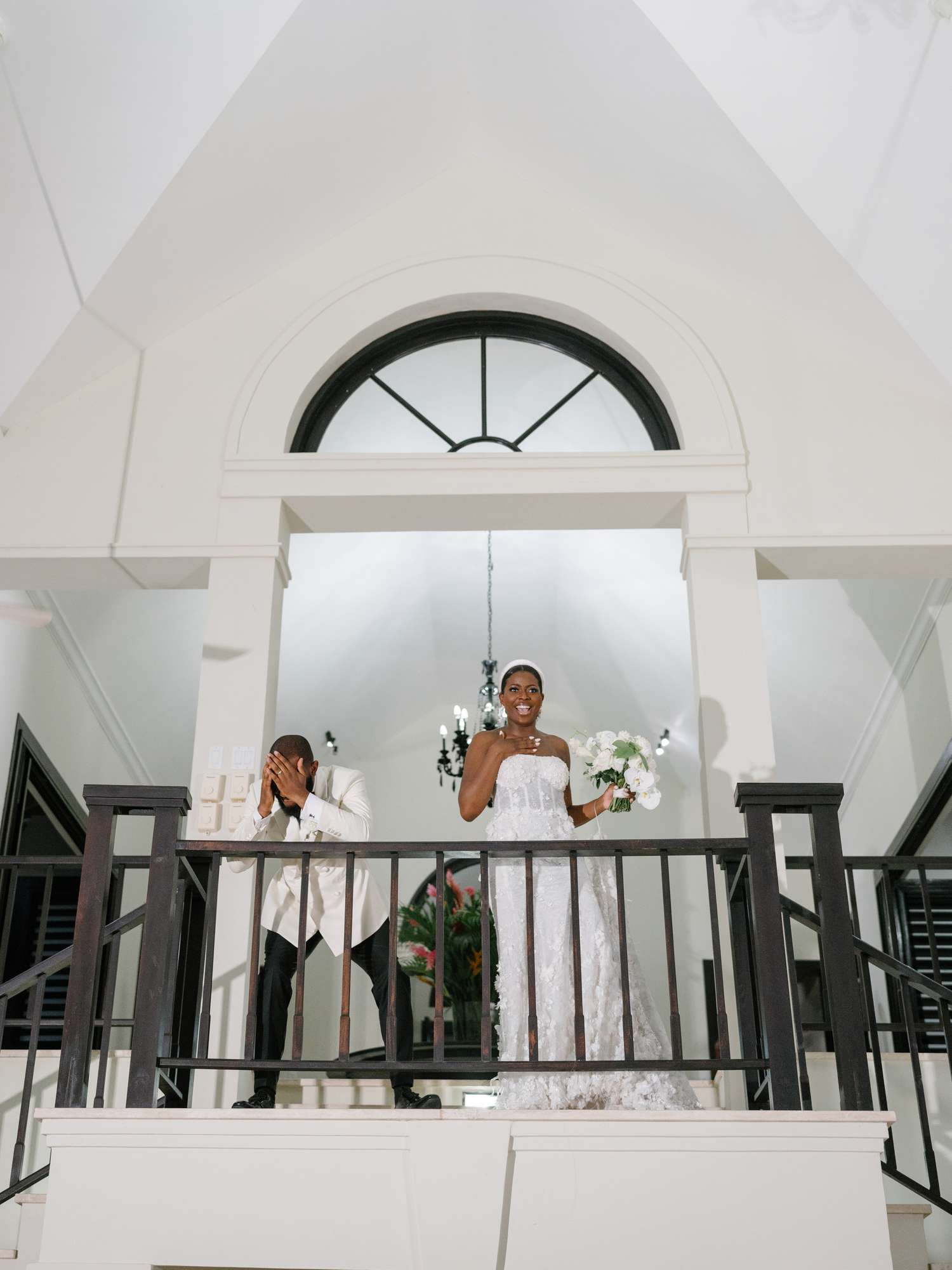 Bride and groom make their grand entrance from balcony at reception