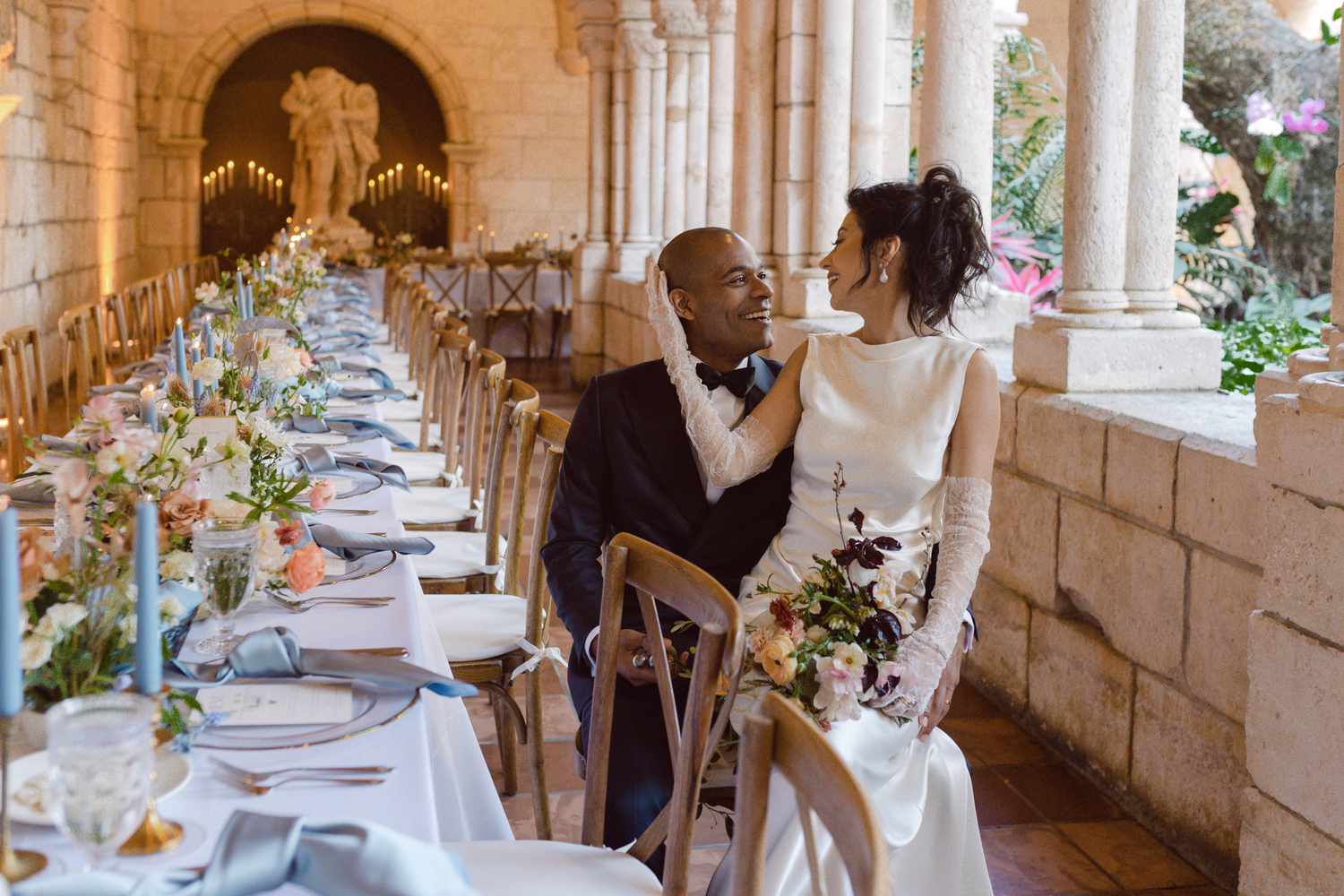 bride and groom sitting at their reception table
