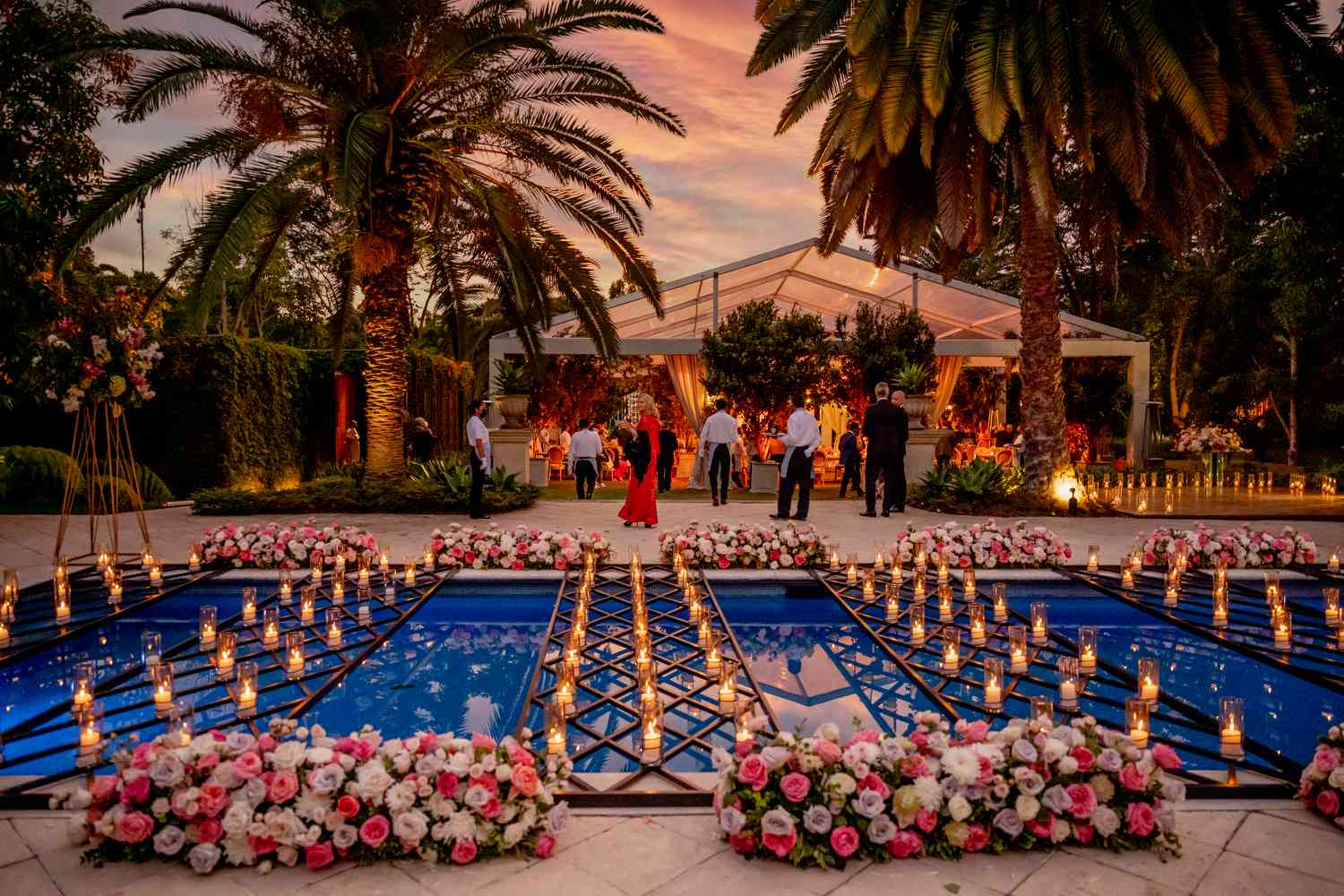 Sarah and Carlos' pool covered in candles and flowers