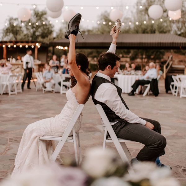 bride and groom playing the wedding shoe game