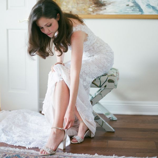 Bride Putting on Pair of Sparkly Silver Wedding Shoes