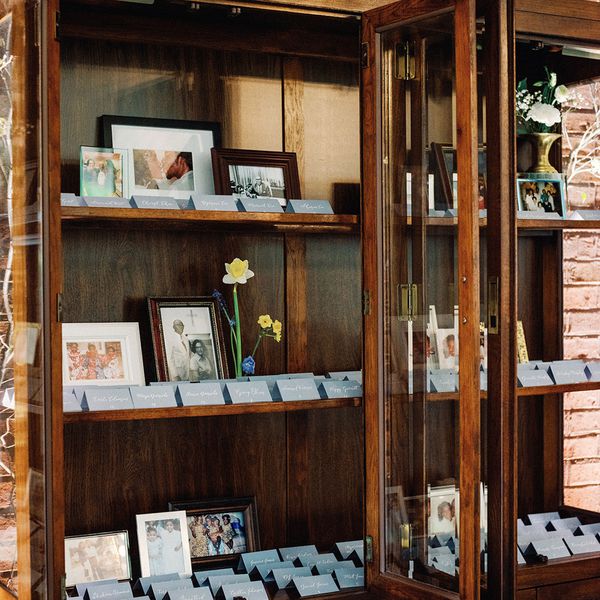 Family Photos Arranged Next to Escort Cards, a Simple Wedding Decoration