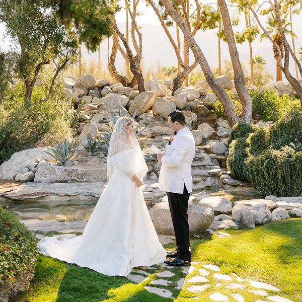 couple reciting wedding vows outdoors