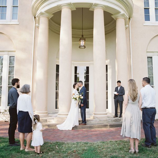 Bride and groom standing in front of church