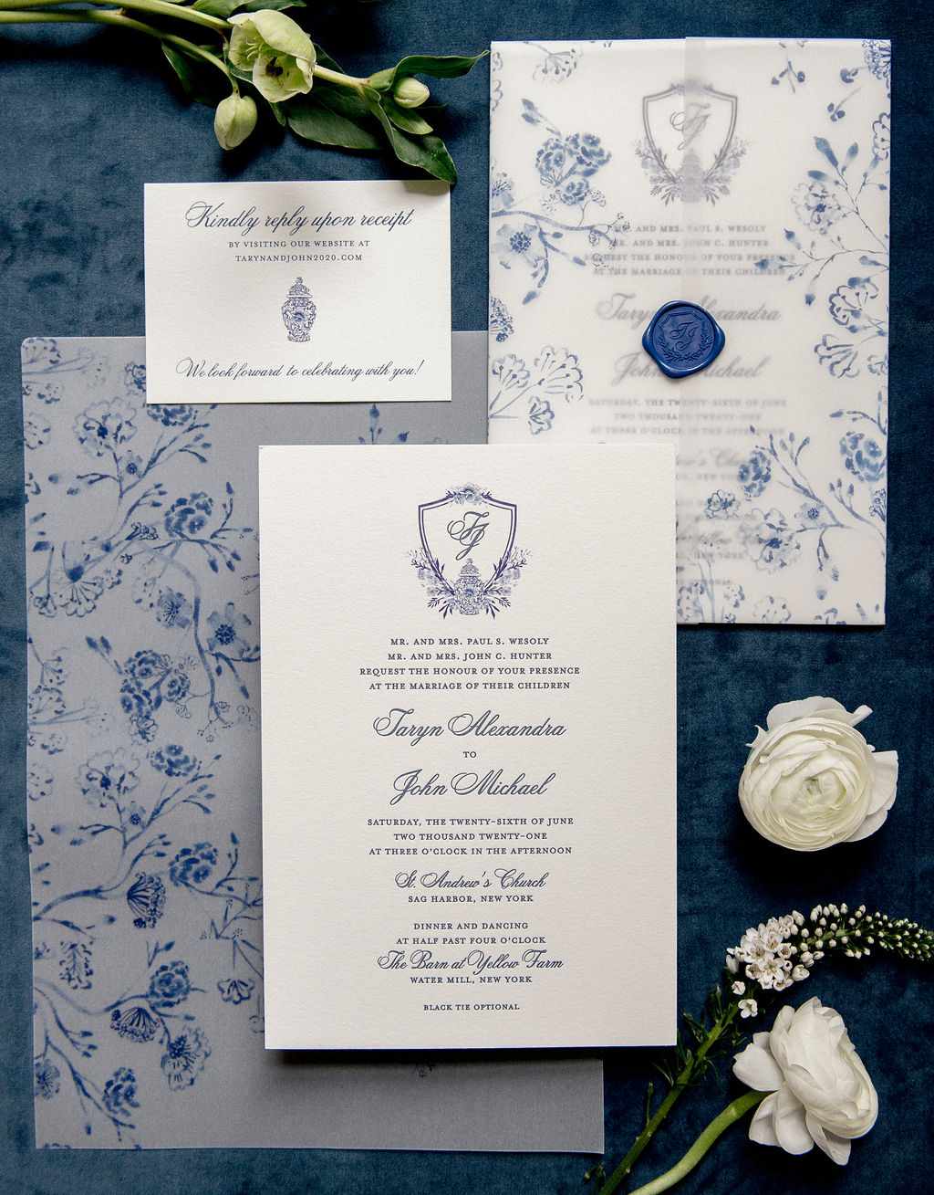 Blue and white chinoiserie-inspired wedding invitation suite with a monogrammed crest