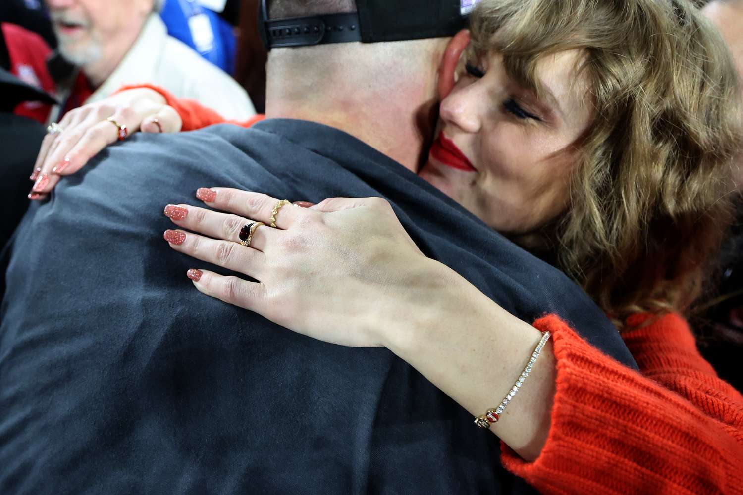 Taylor Swift hugging Travis Kelce and flaunting diamond tennis bracelet with joint initials