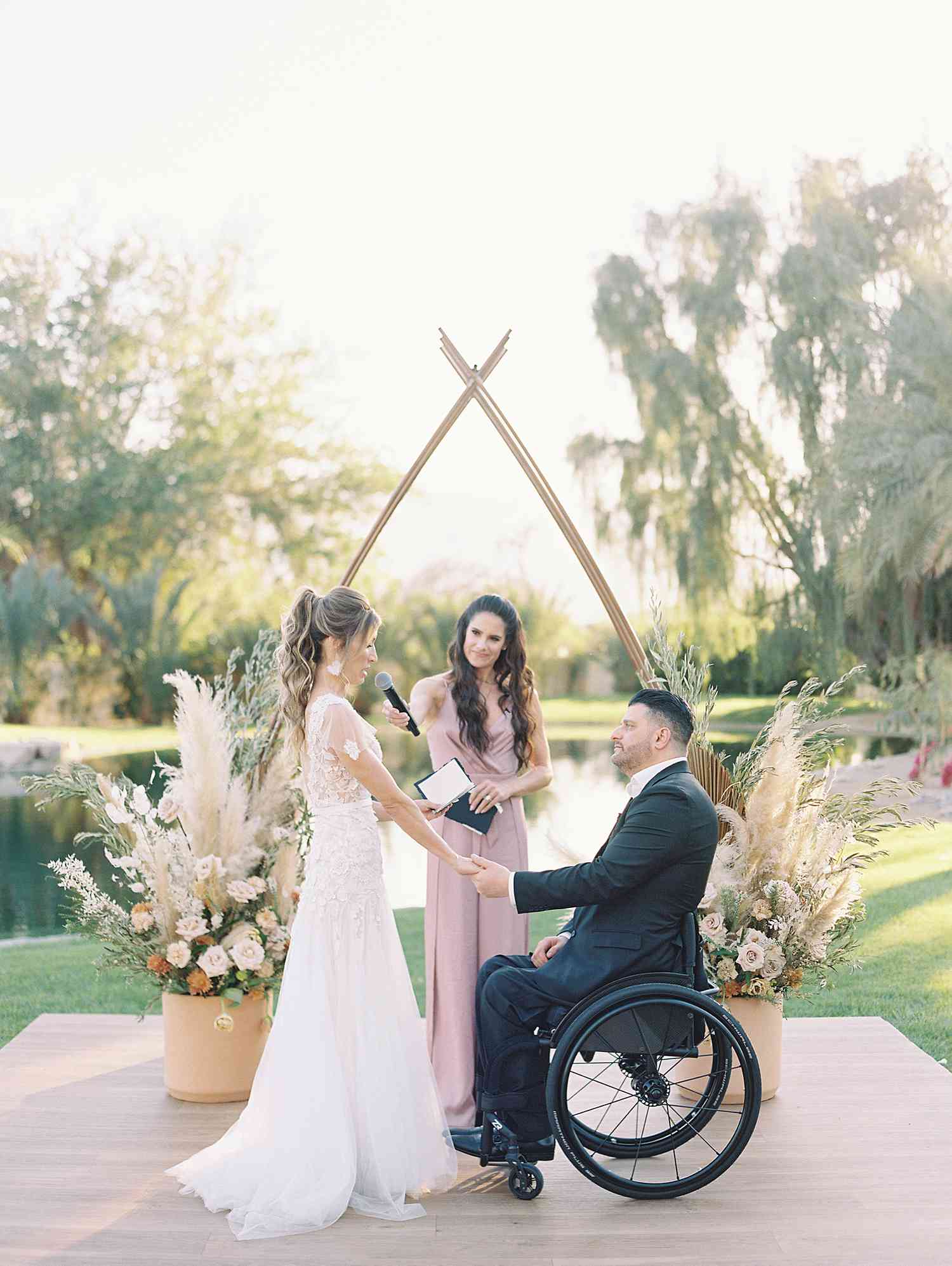 Tiffany and Michael holding hands at the altar