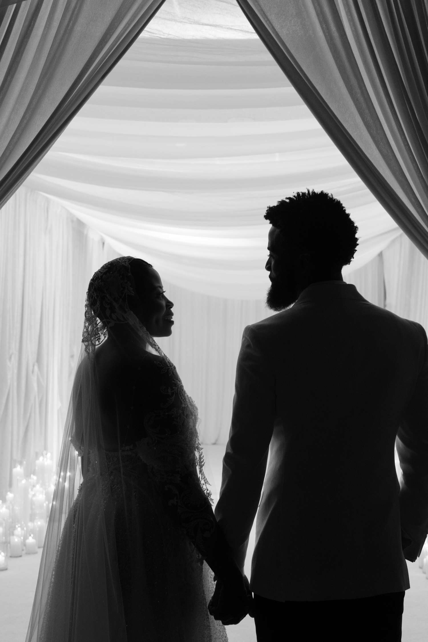 A Couple's Wedding Entrance With Curtains on Either Side of Them