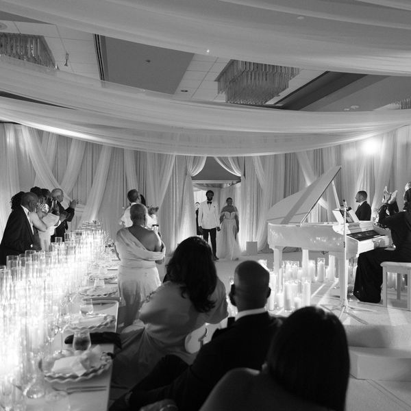 Bride and Groom Enter Wedding Reception With Candles and Grand Piano
