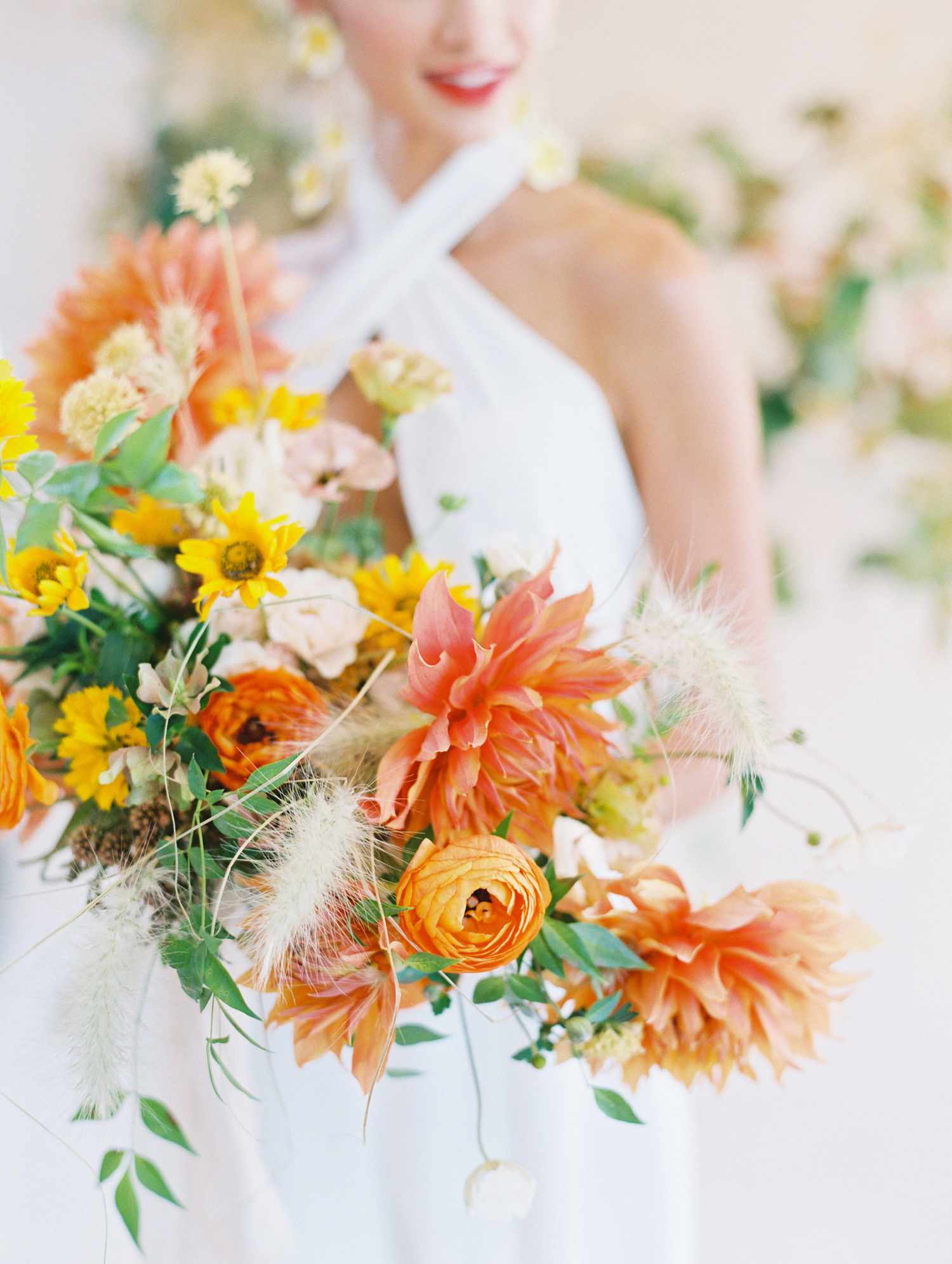 Fall bridal bouquet made up of ranunculus and dahlias