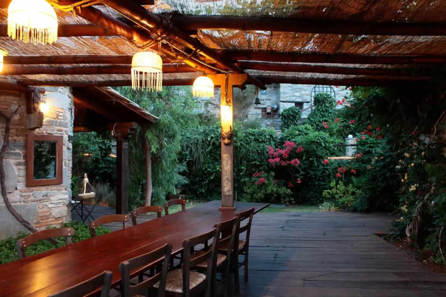 Lush garden with wooden outdoor patio at an Airbnn wedding venue in Greece