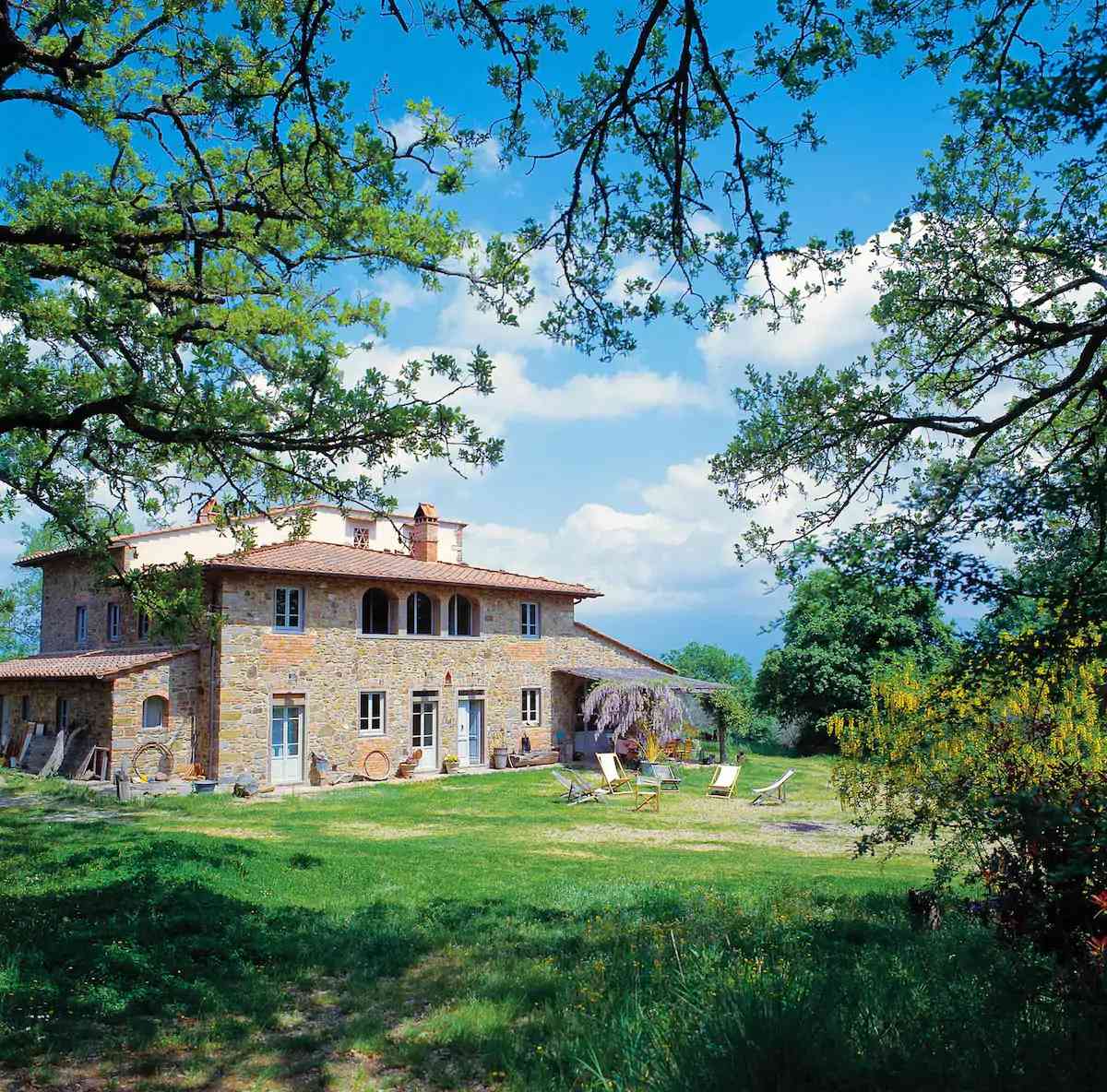Stone villa surrounded by lush green lawn, a wedding venue Airbnb near Florence