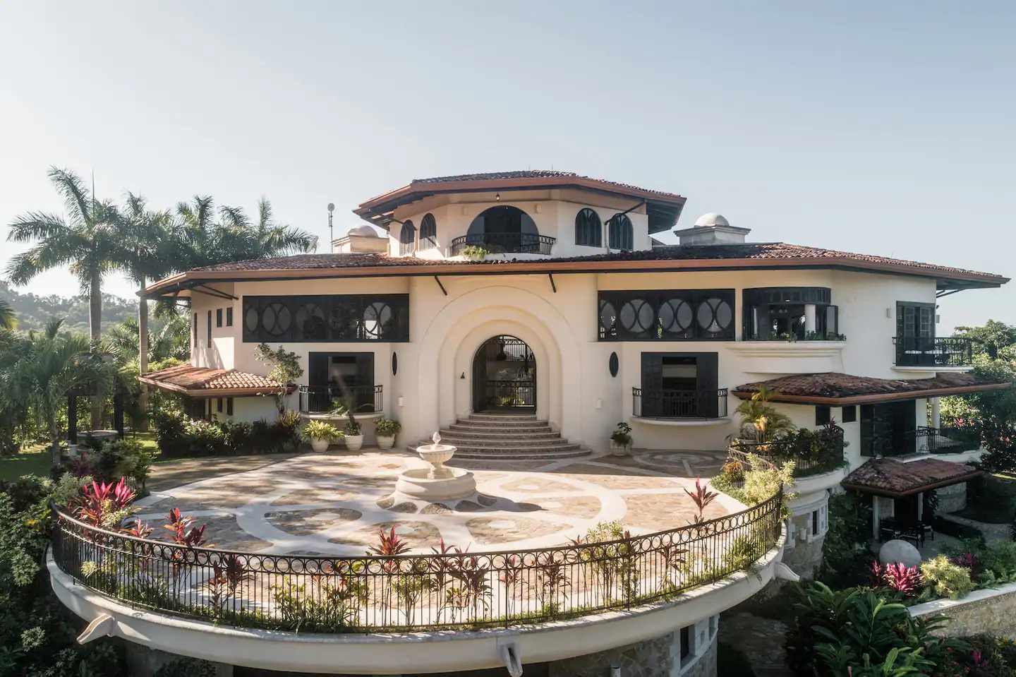 Daytime exterior view of a stone villa Airbnb wedding venue in Costa Rica.
