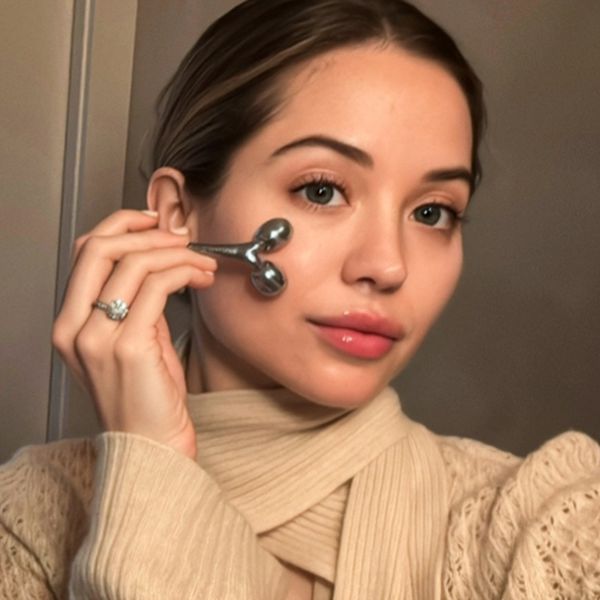 Women using the Gua Sha tool on her face