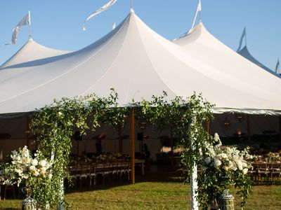 tent wedding venue with floral arch