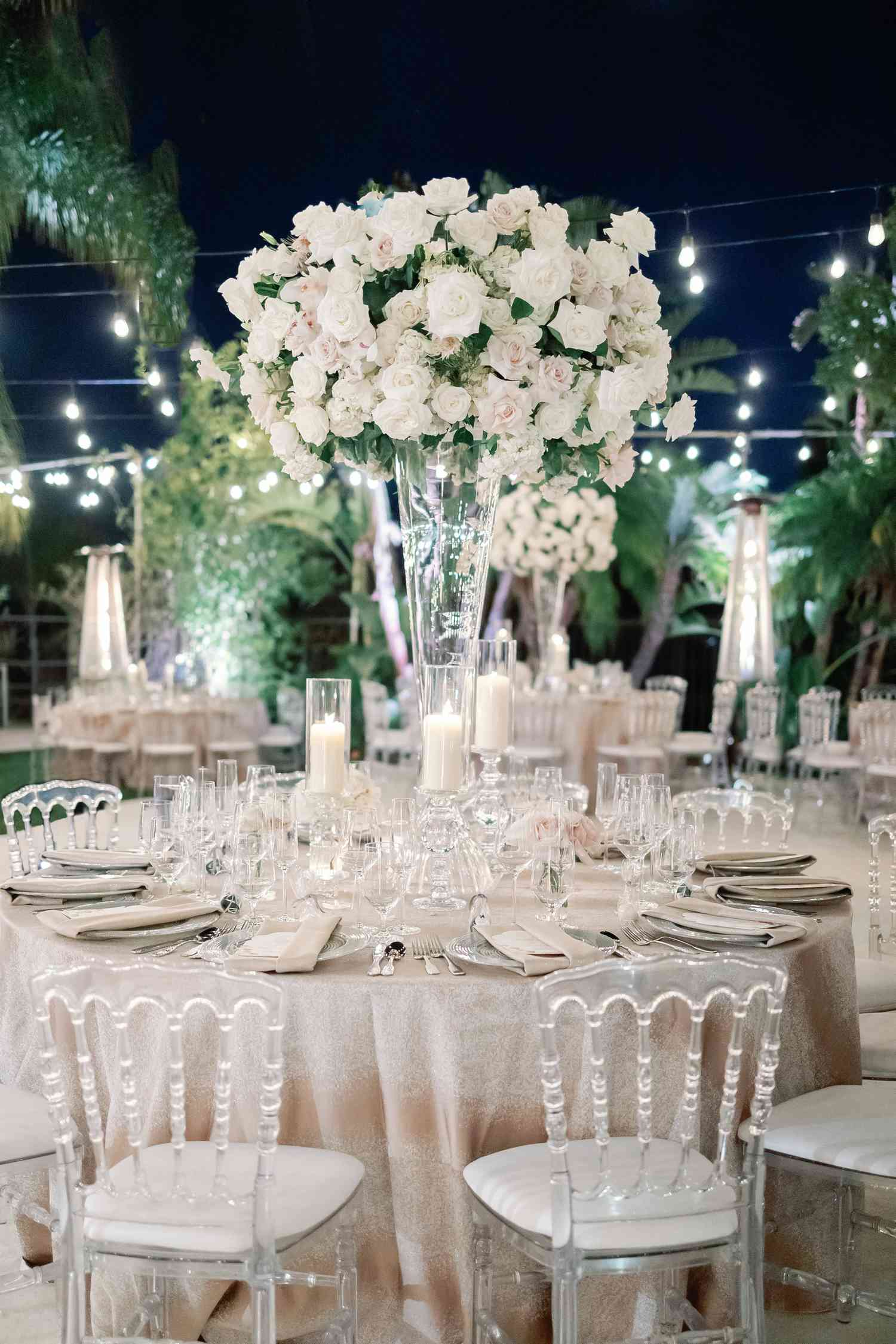 Round Wedding Table With Sparkly Linens and Tall Floral Centerpieces