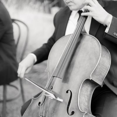 Black-and-White Photo of Man Playing Cello at Wedding Ceremony