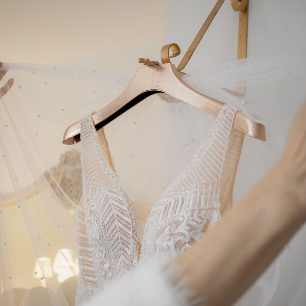 Wedding Dress on a Hanger With a Veil Over It