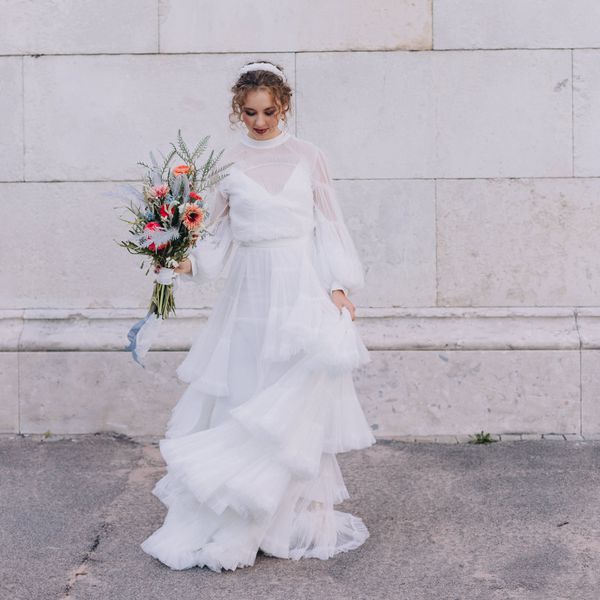 bride wearing a tulle wedding dress, holding a wildflower wedding bouquet