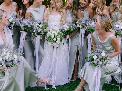 bride and bridesmaids holding purple and white bouquets