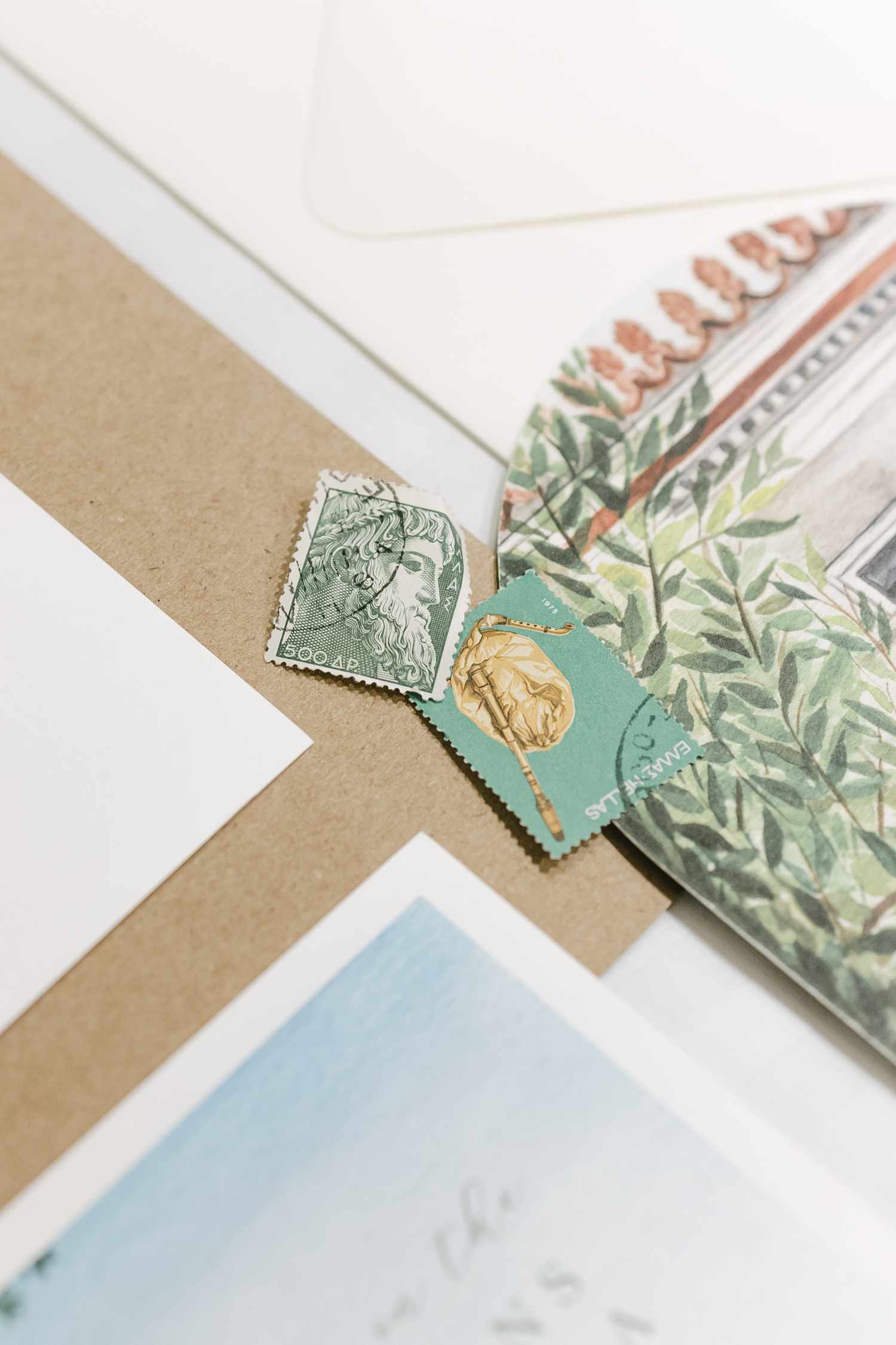 Closeup of Two Postage Stamps on Scattered Invitation Inserts