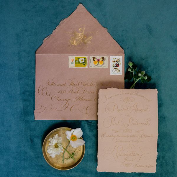 Pink Deckle-Edge Envelope with Stamps and Calligraphy and Matching Invitation on Blue Velvet Fabric