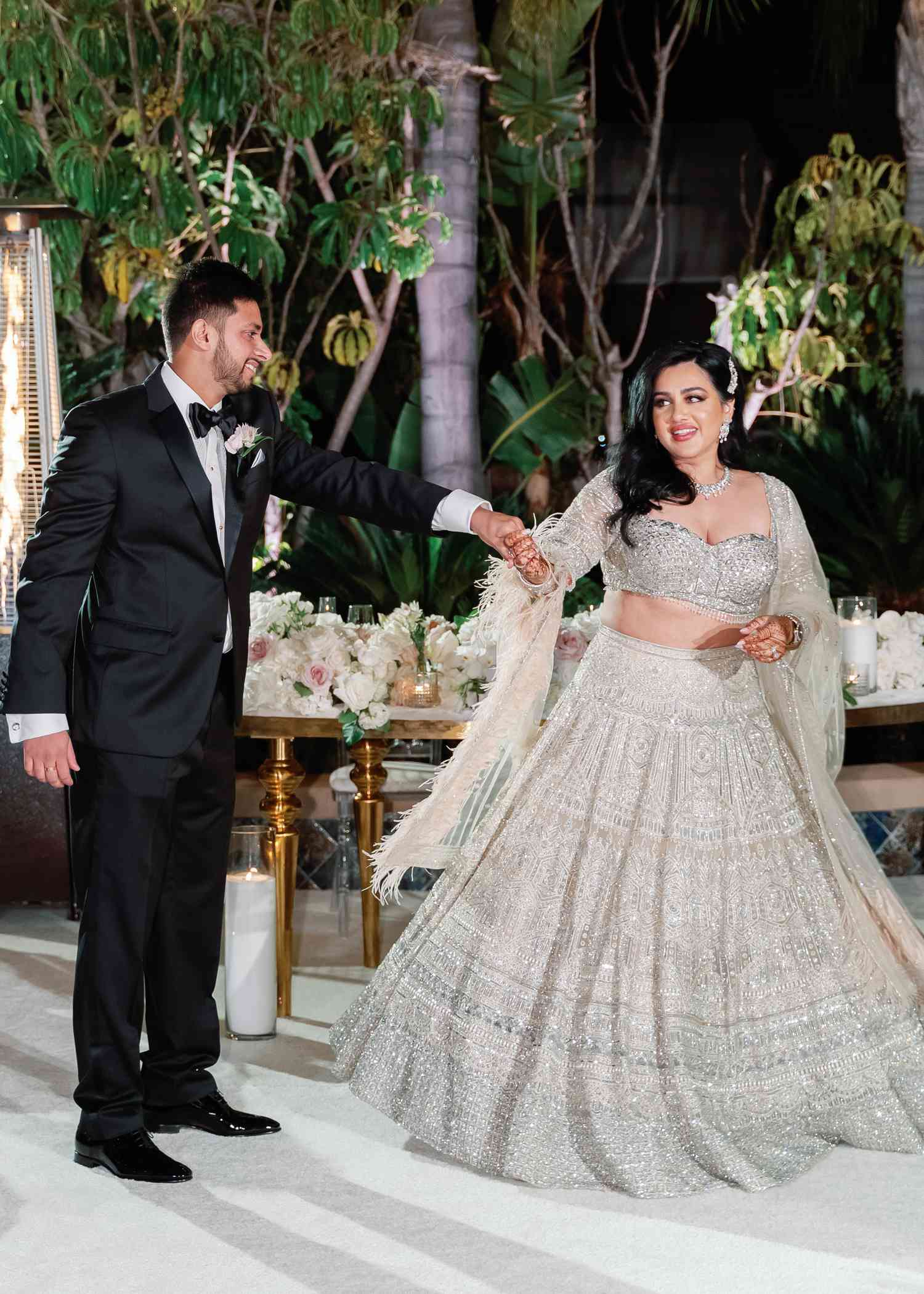 A Bride and Groom Make Their Wedding Entrance While Holding Hands