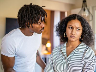 Man Looking at Woman While She Looks Off to the Side