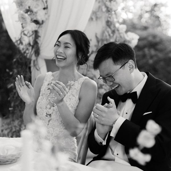 Bride and Groom Laugh in Response to a Wedding Speech