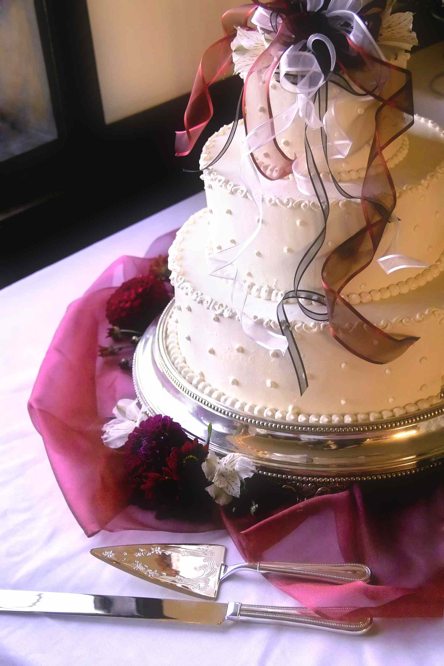Three-Tier White Cake With Purple Ribbons on Top