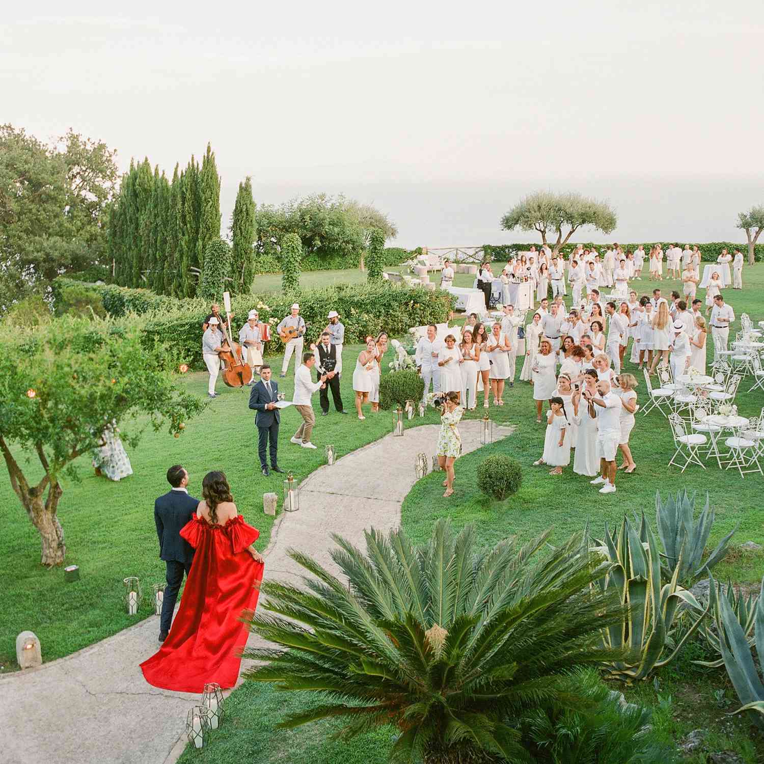 couple walking into their welcome party during wedding weekend