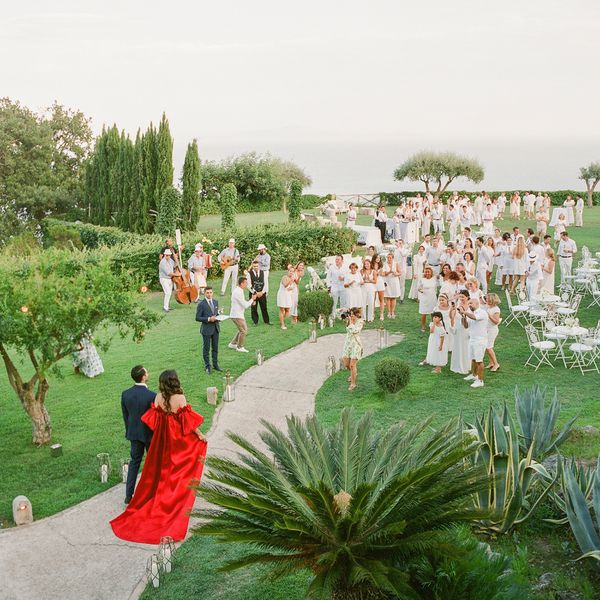 couple walking into their welcome party during wedding weekend